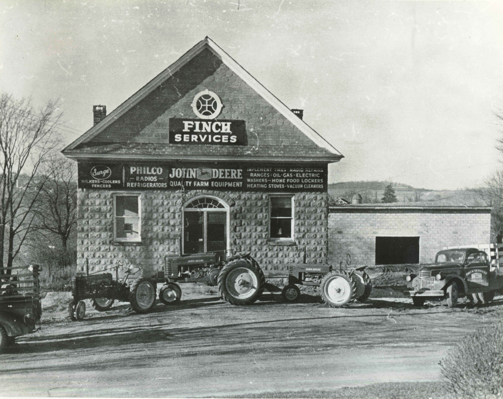 Black-and-white photo of the Finch Services John Deere dealership in Medford, Maryland, with tractors out front