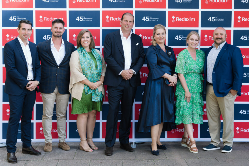Finch together with Redexim in front of the Redexim 45th anniversary backdrop at the celebration in the Netherlands